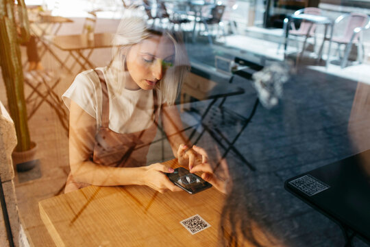 Women scanning a QR Code in a cafeteria