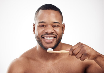 Black man, portrait and brushing teeth or smile cleaning in studio for healthy gums, hygiene or...