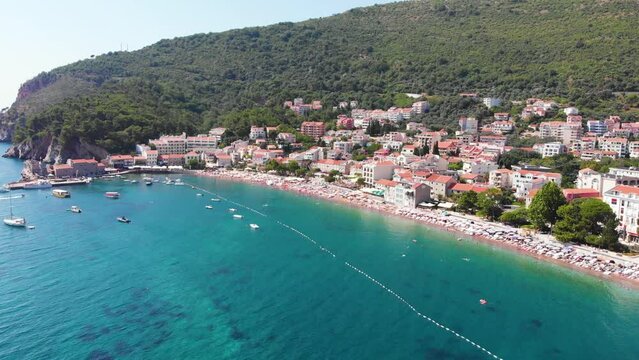 Aerial view of Petrovac, old and modern city on Adriatic Sea coast. Center of Montenegrin tourism and popular sea resort.