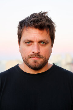 Portrait of confident green eyed man looking at the camera