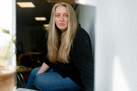a woman in a black sweater and blue jeans 