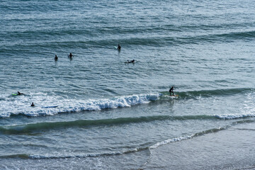 Praia do Beliche beach in Sagres, Algarve, Portugal. Sunny day with surfers in the sea