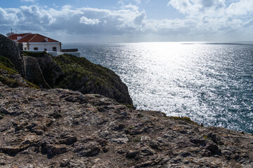 Rocky coastline in Sagres, on the Algarve coast of Portugal. Farol do Cabo de Sao Vincente