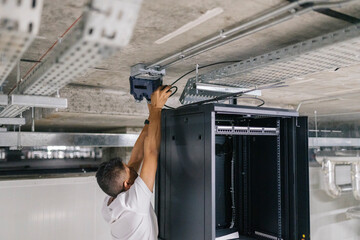 IT engineer installing security server in industry