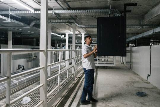Technician installing server in industrial building