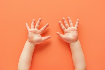 Baby on pastel orange background reaches out with tiny hands