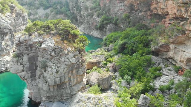 Aerial video of the mountain Moracha River canyon in Montenegro. Relax natural scenery, wild nature landscape, towering cliffs, clear river, green tourism, wanderlust.