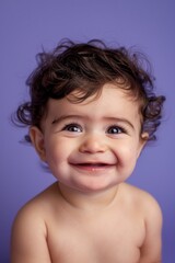A joyful baby sheds tears of happiness against a soft pastel purple backdrop