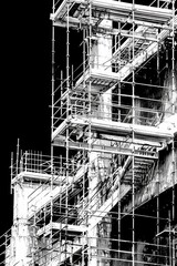 Obraz premium Black and white photo of a building with scaffolding. Suitable for construction industry projects