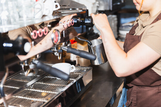 Side view of barista checking for payment receipt