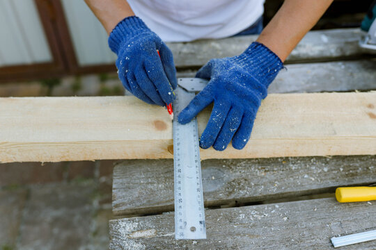 a man processes wood in the yard