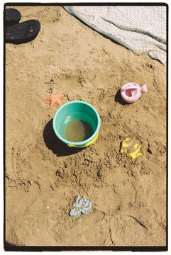 Child's beach toys in the sand