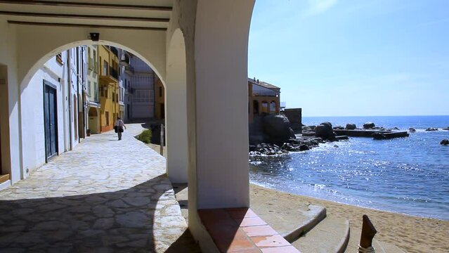 Arcade with path along the beach at Port Bo beach. Calella de Palafrugell, Costa Brava, Catalonia, Spain.