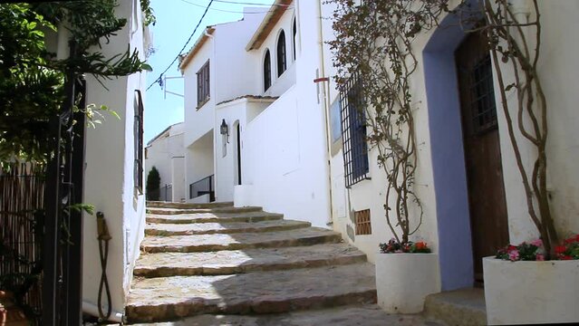 Typical street of the old town of Calella de Palafrugell with stone steps and white walls. Costa Brava, Catalonia, Spain.