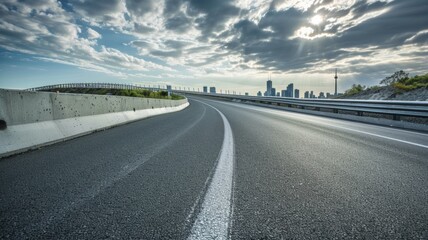 curved asphalt highway road and city skyline afternoon light.