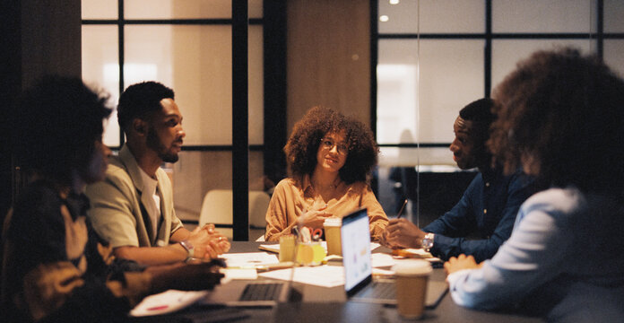 Modern businesspeople discussing work in meeting room