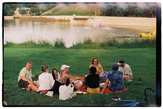 Group of young people picnicking in park