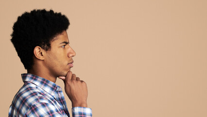 Searching for idea. Thoughtful afro guy profile portrait on white, copy space