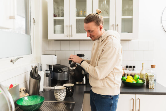Man making tea in the kitchen
