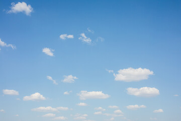 Light blue sky with small white clouds