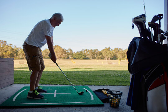 Portrait of a man practicing golf
