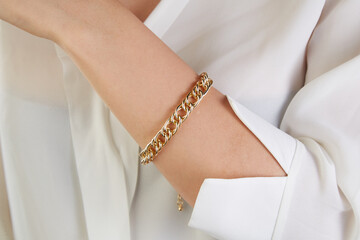 Gold jewelry. Gold bracelet on woman hand