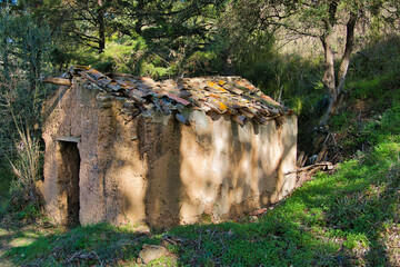 Neglected, half-collapsed old mud hut in the rural hinterland of the Algarve, Portugal
