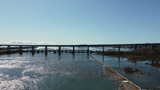 Sault Ste. Marie Canada flying under the bridge over the water drone shot two