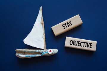 Stay Objective symbol. Wooden blocks with words Stay Objective. Beautiful deep blue background with...