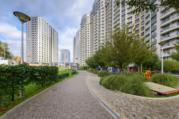 Urban area with tall buildings, green spaces, blending city lifestyle with nature and architecture