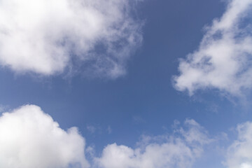 White clouds in a clear blue sky.