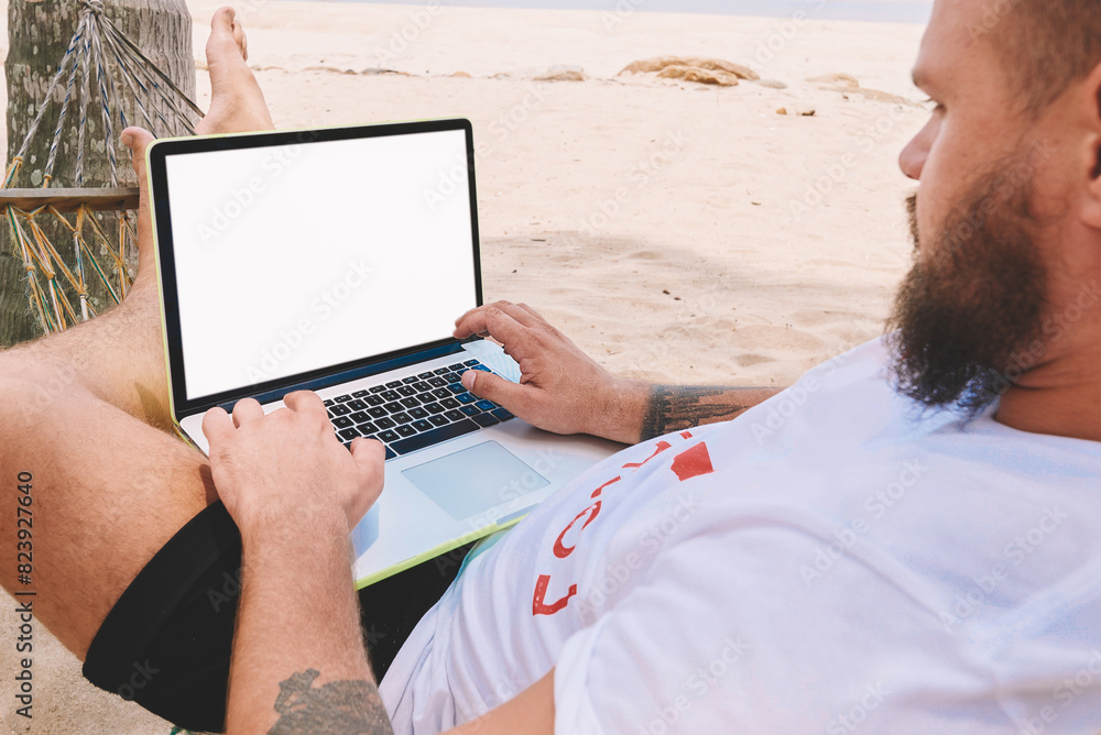 Poster male businessman tourist typing text on keyboard of computer with blank screen for your internet web