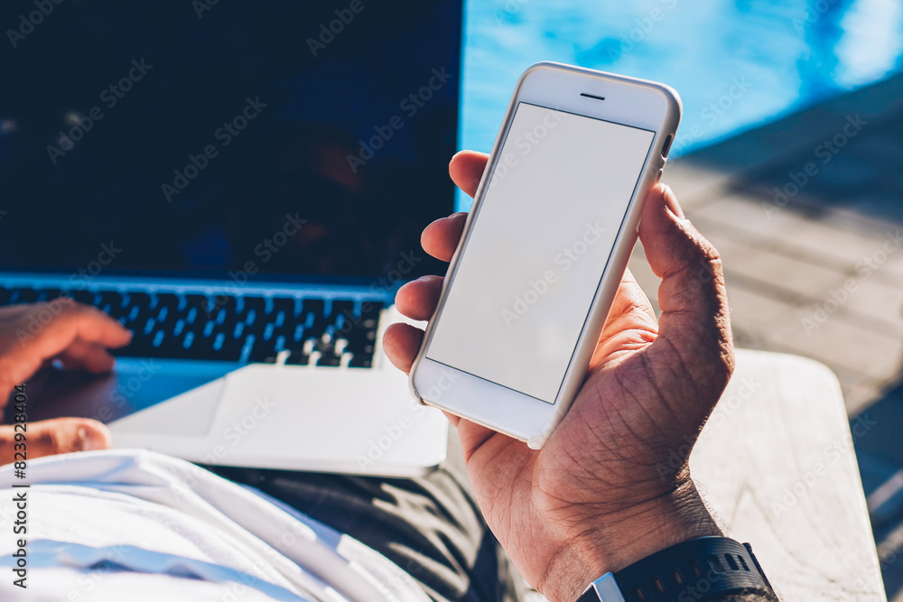 Poster croped image of man tourist holding modern smartphone with blank copy space screen for your advertis