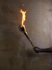 wooden fire torch in hand