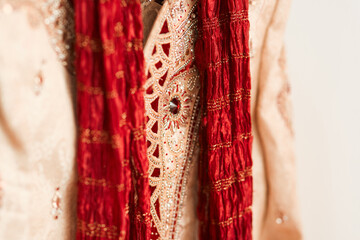 Indian groom, wedding and closeup for attire, clothes and rack, culture and traditional in choice....