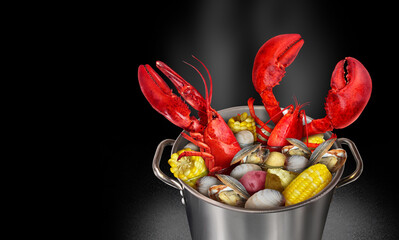 Lobster Bake Pot or lobsters boiling with corn clams and potatoes as a classic Atlantic coast festive meal and seafood cooking in New England.