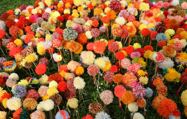 Many flowers made with numerous soft pompoms made with colorful soft wool threads