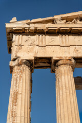 Upper part of an ancient Greek temple, The Parthenon. It features Doric columns and a pediment...