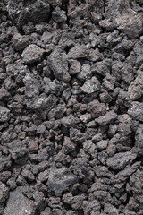 A pile of rocks is shown in a close up. The rocks are brown and appear to be small and rough. Concept of ruggedness and natural beauty