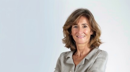 Obraz premium portrait of a smiling Mature brunette businesswoman looking at the camera on white background