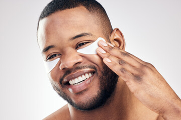 Studio, skincare and black man with facial patches for wrinkles, fine lines or cosmetics. Male...
