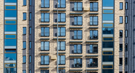 Fototapeta premium Modern apartment building. Residential condo house, exterior architecture new city home. Living block flat window balcony, luxury facade estate property urban high tower. Contemporary rental town