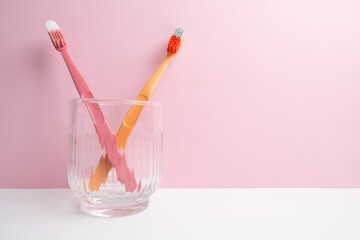 Colored toothbrushes on a color background. Replace your old toothbrush with a new one. Old and new toothbrushes. Dental health and hygiene concept