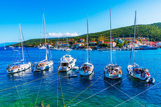 Fiskardo, Kefalonia, Greece: Panoramic view of the Fiskardo bay over the village and the boats ancored in the bay, Ionian island, Europe