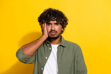 Portrait photo of young latin guy in khaki shirt stressed and tired after over drinking night...