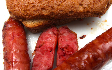 sausages with a piece of bread. sliced sausages. sausages prepared for the meal.