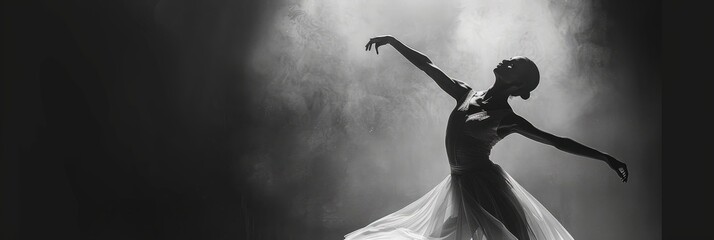 A black and white photograph of a graceful ballerina performing a classical ballet dance routine