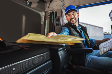 Portrait Of Courier With Delivering Letters. Young handsome delivery guy getting his deliveries...