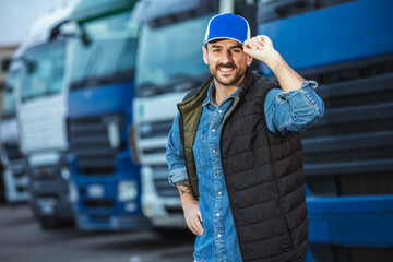 Happy confident male driver standing in front on his truck