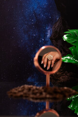A womans hand adorned with a pearl ring is reflected in a mirror